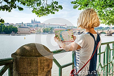 Young female tourist studying a map of Prague. Stock Photo