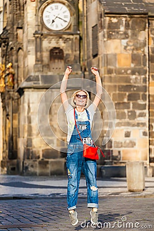 Young female traveler jumping with joy at the Old Town Square in Prague. Stock Photo