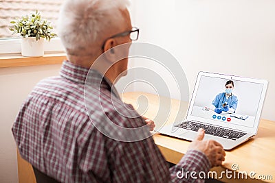 Young female UK e-doctor consulting elderly man, online video help line virtual medical appointment Stock Photo