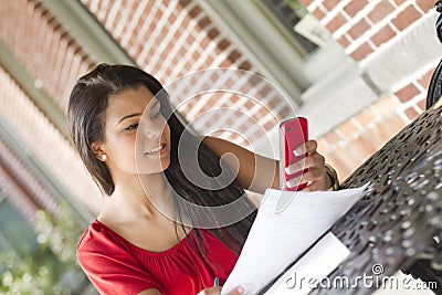 Young female using her mobile phone to text Stock Photo