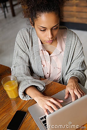 Young female worker typing on laptop Stock Photo