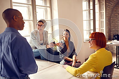 Female workers in office talking with male manager Stock Photo