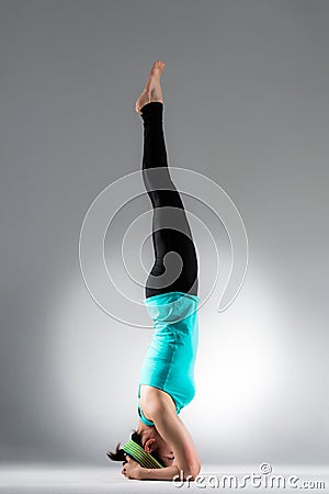 Young female yoga student handstand on floor Stock Photo