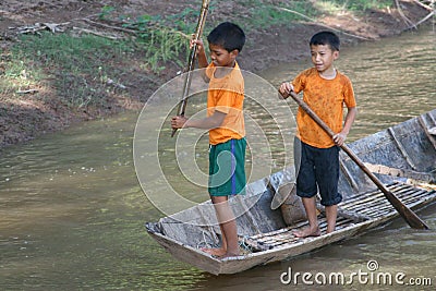 Young fishing boys are gaming and fishing at Mekong river in Laos Editorial Stock Photo