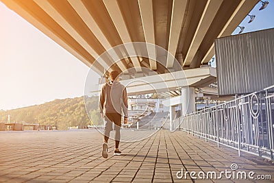 Young fit man running at outdoors, autumn , attractive dark skinned runner jogging fast, sport concept Stock Photo