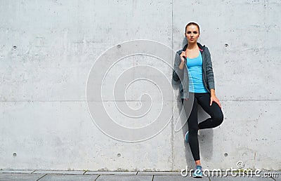 Young, fit and sporty brunette girl in sportswear. Woman doing sports outdoor. Stock Photo