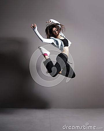 A young and fit woman dancing in sporty clothes Stock Photo