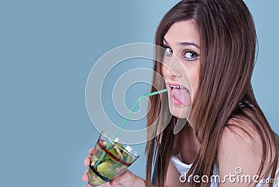 Young fit woman holding a glass with kiwi pieces Stock Photo