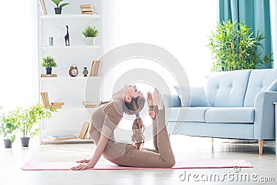 Young fitness beautiful woman female doing sport exercise deflection and yoga workout on mat in morning. Healthy lifestyle, Stock Photo