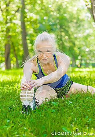 Young fitness girl warm up before a morning workout Stock Photo