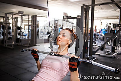 Young fitness woman performing lats pulldown Stock Photo