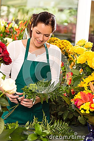 Young florist preparing flowers bouquet shop store Stock Photo