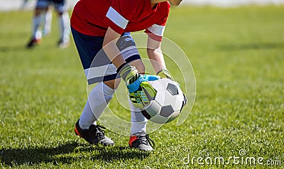 Young Football Goalkeeper Catching Soccer Ball During Tournament Match Stock Photo
