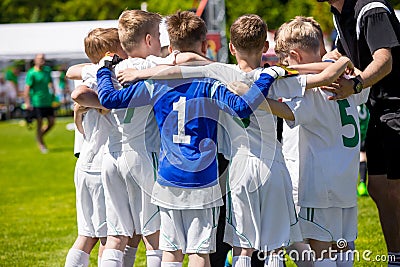 Young football soccer players in sportswear. Coach Motivating Kids In Sports Editorial Stock Photo