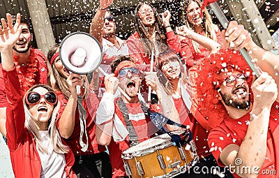 Young football supporter soccer fans cheering with flag and confetti Stock Photo