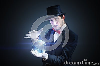 Young fortune teller is predicting future from magical crystal ball Stock Photo