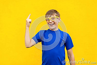 Young freckled boy has an idea, pointing with finger up isolated Stock Photo