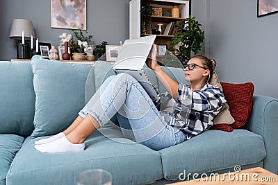 Young freelance business woman working at home on laptop as product strategy expert. Female expatriate remote work on internet on Stock Photo