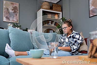 Young freelance business woman working at home on laptop as product strategy expert. Female expatriate remote work on internet on Stock Photo