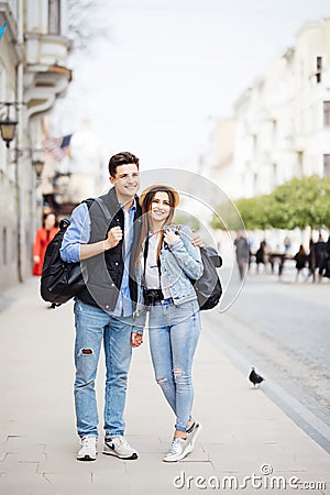 Young freelancing photographers enjoying traveling and backpacking. Young couple with backpack travel new destination Stock Photo