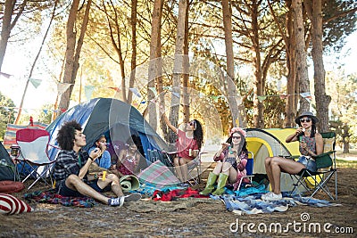 Young friends enjoying together at campsite Stock Photo