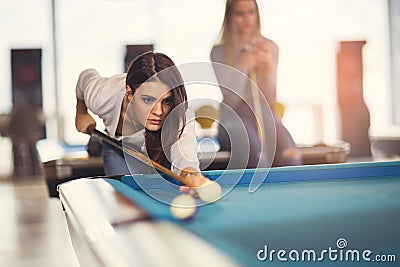 Young friends playing billiard Stock Photo