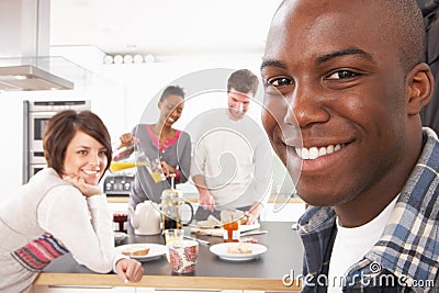 Young Friends Preparing Breakfast In Kitchen Stock Photo