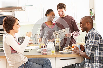 Young Friends Preparing Breakfast In Kitchen Stock Photo