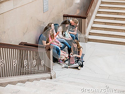 Young friends relax on Grand Staircase at Art Institute of chicago Editorial Stock Photo