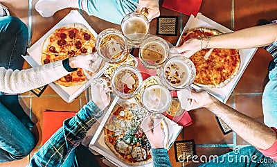 Young friends roomates eating take away pizza at home after college - Friendship concept with people students enjoying time Stock Photo