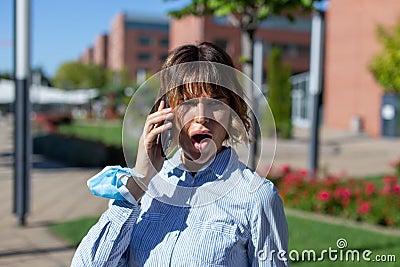Young frightened businesswoman in park calling by phone Stock Photo
