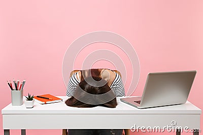 Young frustrated exhausted woman laid her head down on the table sit work at white desk with contemporary pc laptop Stock Photo