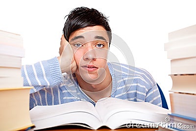 Young frustrated male student between study books Stock Photo