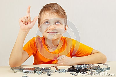 Young funny engineer thinks that assemble from mechanical constructor Stock Photo