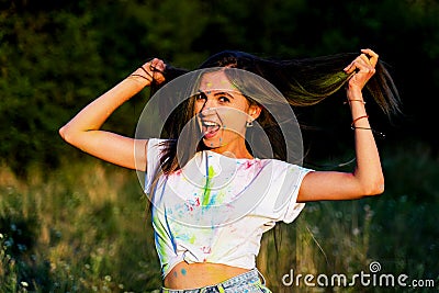 A young funny girl smeared with paint smiles Stock Photo