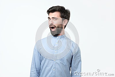 Young funny hispanic man with black beard is shocked and suprised. Stock Photo