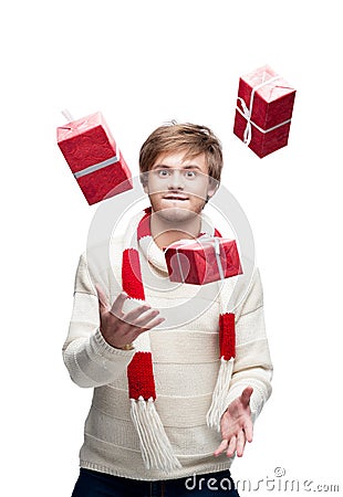 Young funny man juggle the christmas gifts Stock Photo