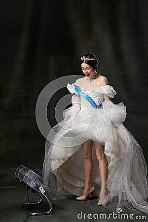 Young funny queen. Portrait of adorable girl in image of medieval royal person in renaissance style dress on Stock Photo
