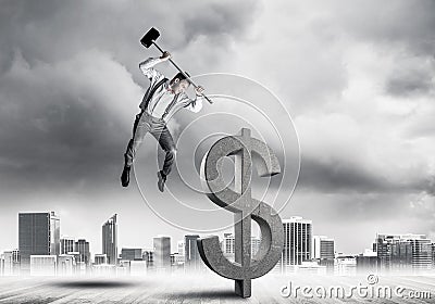Determined banker man against modern cityscape breaking dollar c Stock Photo