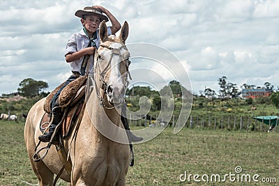 Young gaucho in the Traditional Fest of lasso and dressage Editorial Stock Photo