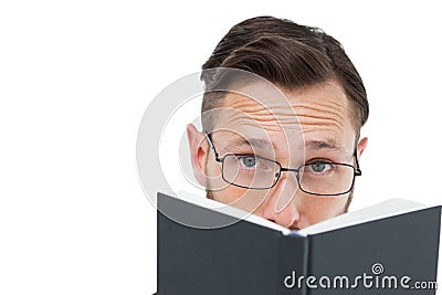 Young geek looking over black book Stock Photo