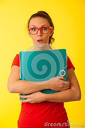 Young geek woman in red t shirt over vibrant yellow background Stock Photo