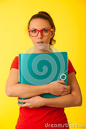 Young geek woman in red t shirt over vibrant yellow background Stock Photo