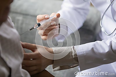 Young general practitioner is making vaccination injection Stock Photo