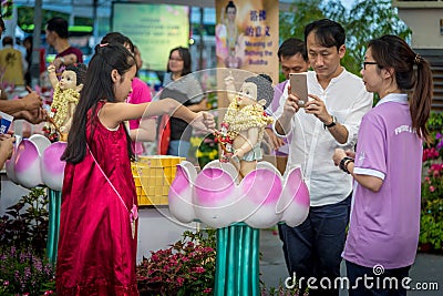 Young Girl Bathing the Buddha during Vesak Day Editorial Stock Photo