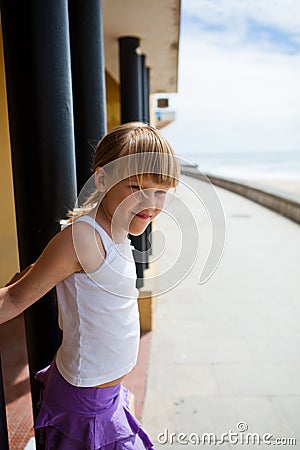 Young girl on beachside walkway Stock Photo