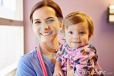 Young Girl Being Held By Female Pediatric Nurse Stock Photo