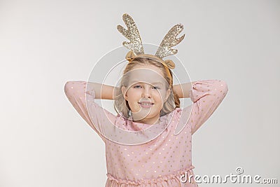 Young girl with a big smile holding her hands behind her head on the deer antler head Stock Photo