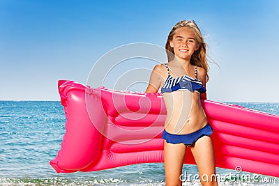 Young girl in bikini with pink inflatable mattress Stock Photo