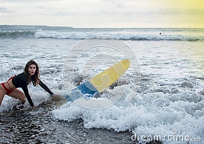 Young girl in bikini - surfer with surf board dive underwater with fun under big ocean wave. Family lifestyle, people Stock Photo